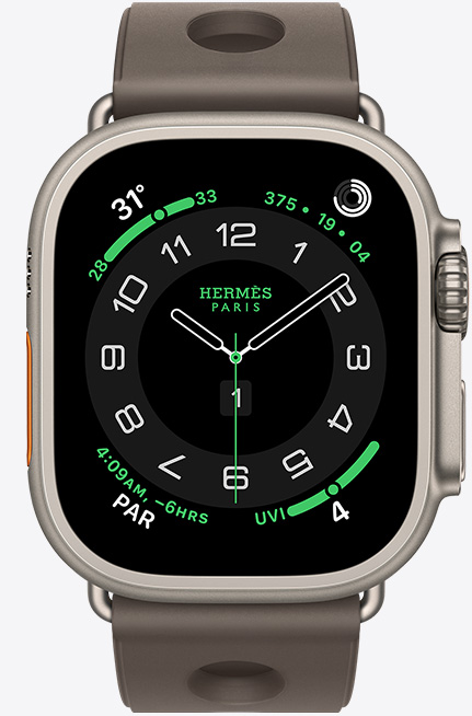 Apple Watch Hermès Ultra 3, titanium case, natural colour, Hermès Circulaire watch face, complications: weather, activity rings, Paris time, UV index, right side exterior, Digital Crown, microphone, raised side button, Scub’H Diving strap, gris titane colour