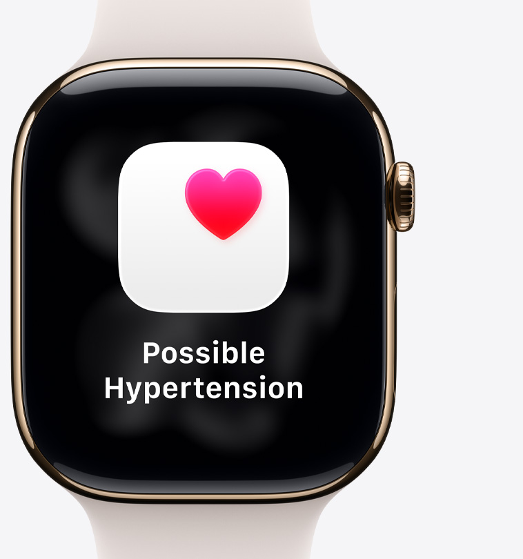 Apple Watch Series 11, titanium case, polished gold color, possible hypertension notification, pink heart in white box, right side exterior, Digital Crown, light blush Sport Band